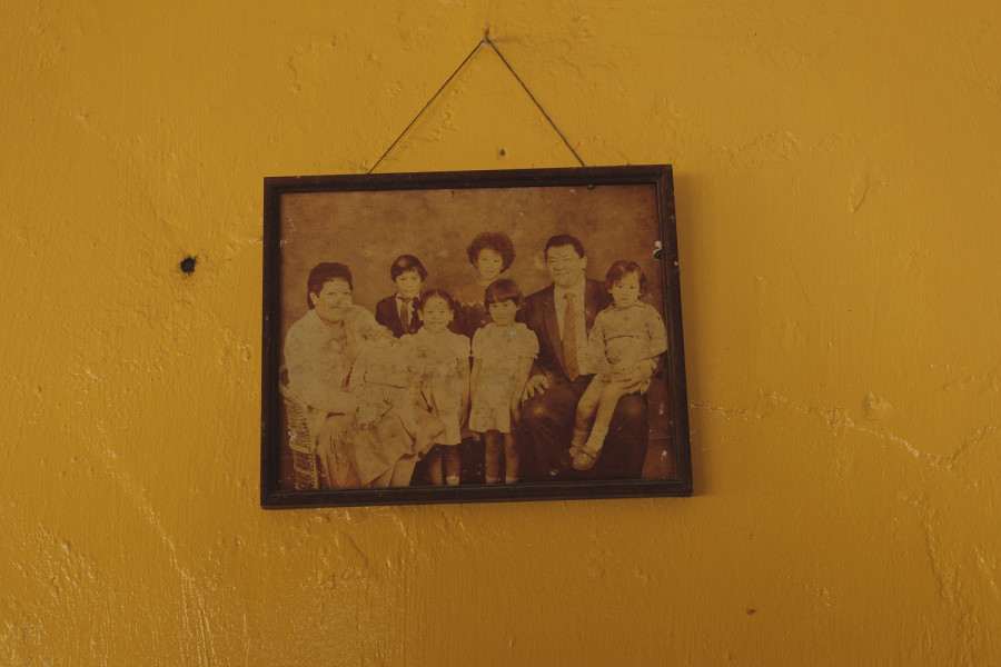 A family portrait at the home of one of the Coral Kids. Like many older houses in Aitutaki, it is built from coral.